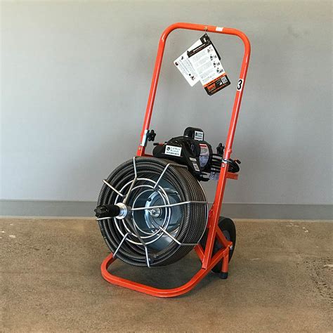 This easy-rooter plumbing snake drives up to 100 ft. of 3/4″ cable to clear 3" to 10" drain lines. The reinforced powder-coated steel frame is built to take heavy-duty use and abuse, and a passive wheel brake locks the machine into position on the job. This equipment is lightweight and easy to use. 